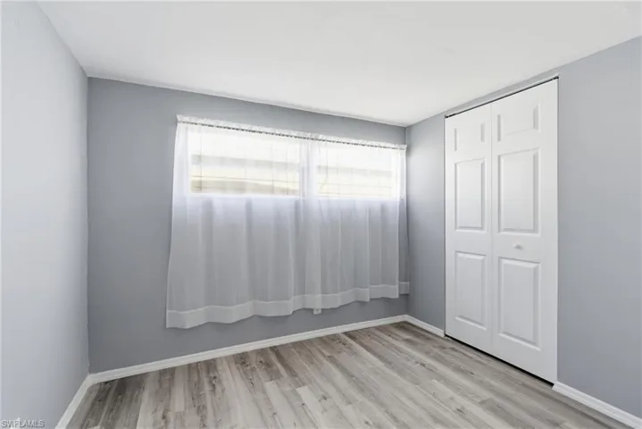 Unfurnished bedroom with a closet and light wood-style flooring