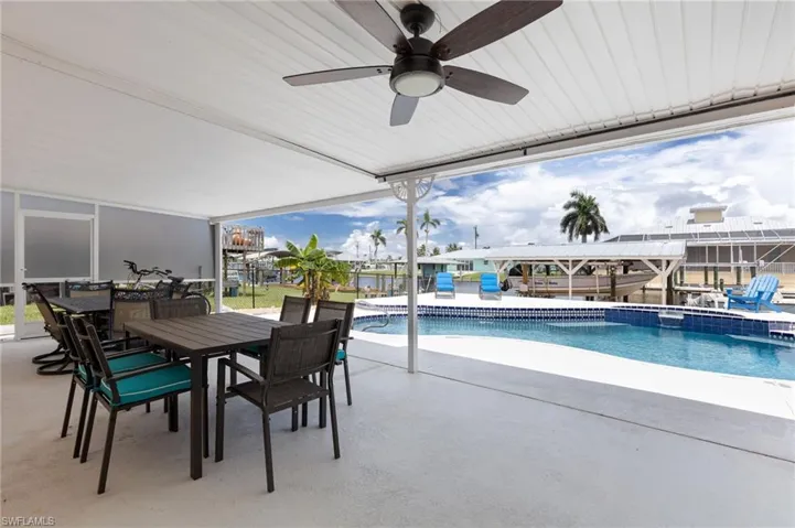 View of swimming pool with a patio area, a pool with connected hot tub, and outdoor dining area