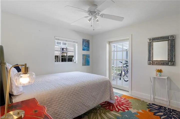 Bedroom with access to outside lanai and ceiling fan