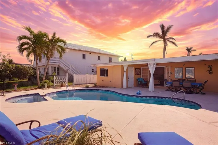 View of swimming pool featuring a patio area and a pool with connected hot tub