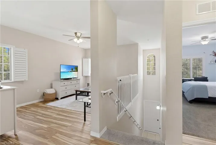 Private entry leading to spacious second floor living with newly painted stair railing.