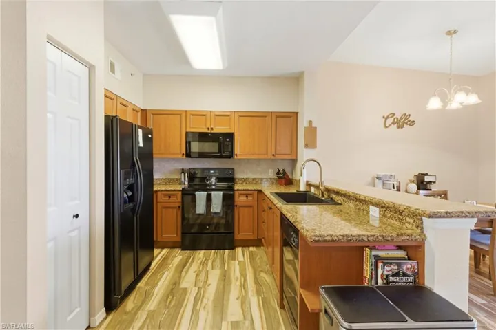 Updated kitchen featuring granite countertops, new backsplash, modern hardware, and modern appliances.