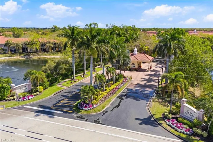 Gated community entrance with serene landscaping and lake views.