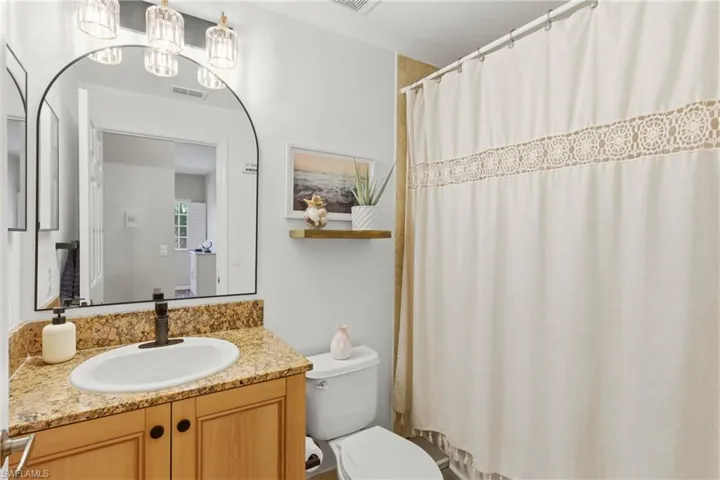 Updated guest bath with new mirror, fixtures, and fresh paint.