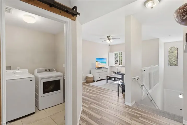 Functional laundry space with custom barn doors for added style.