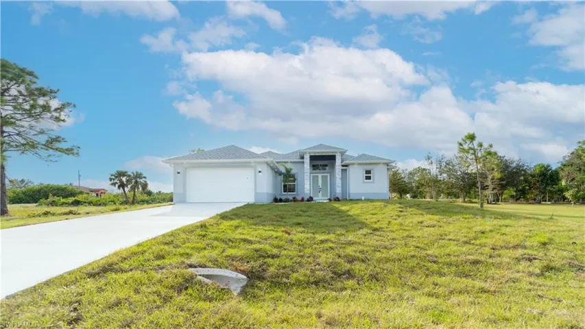 View of front of property with a front lawn and a garage