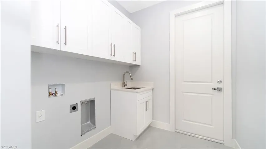 Laundry area featuring cabinets, hookup for an electric dryer, sink, and hookup for a washing machine