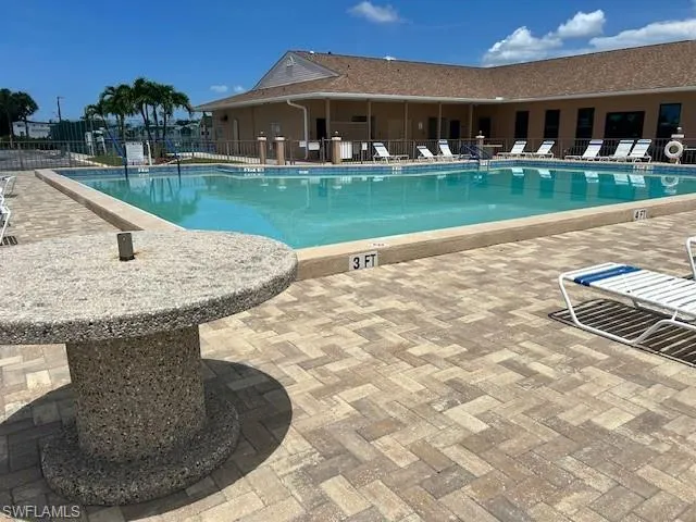 Community pool featuring a patio