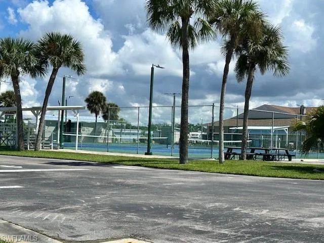 Surrounding community featuring a tennis court