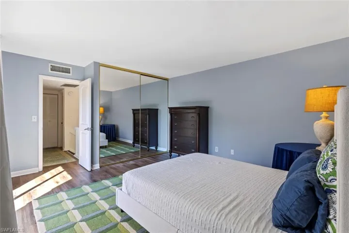 Bedroom featuring wood finished floors and a closet