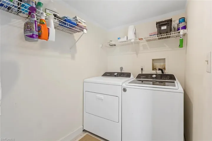 Washroom with independent washer and dryer and baseboards
