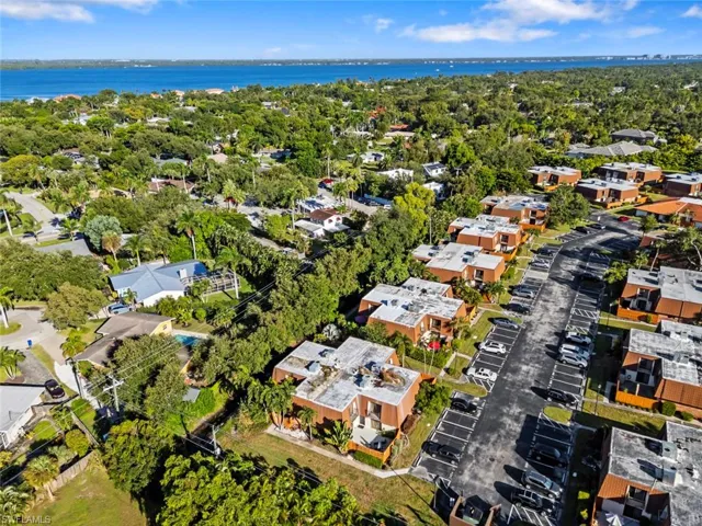 Aerial overview of property's location with nearby suburban area and a large body of water