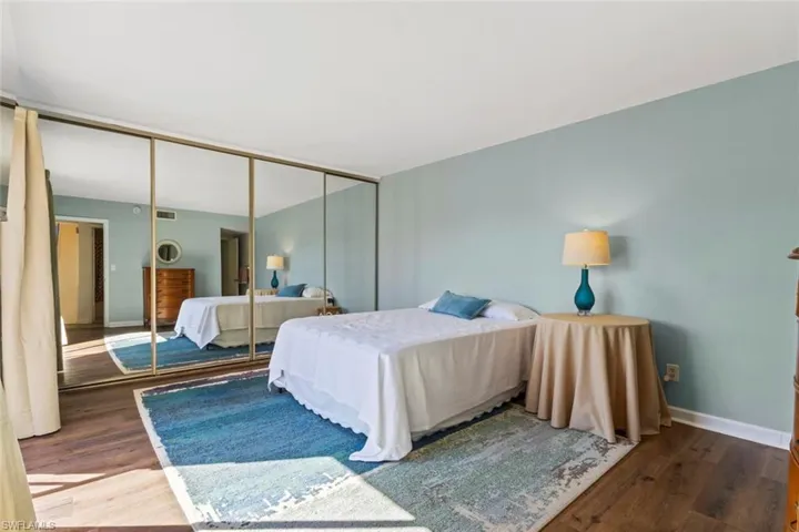 Primary Bedroom with wood finished floors and a closet