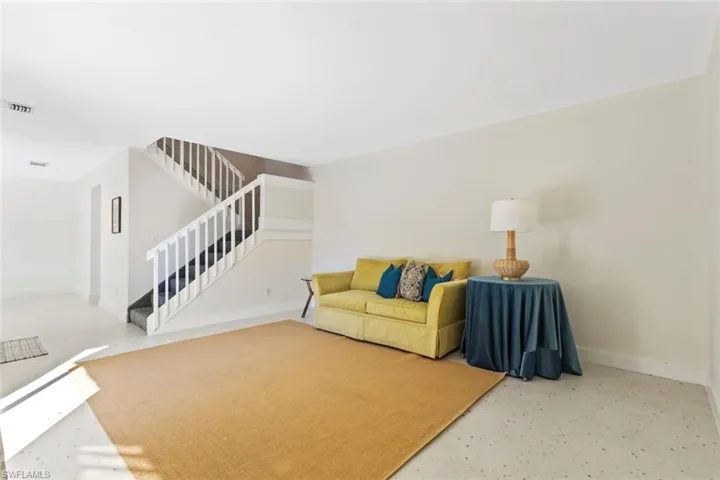 Living area with stairs and finished concrete flooring