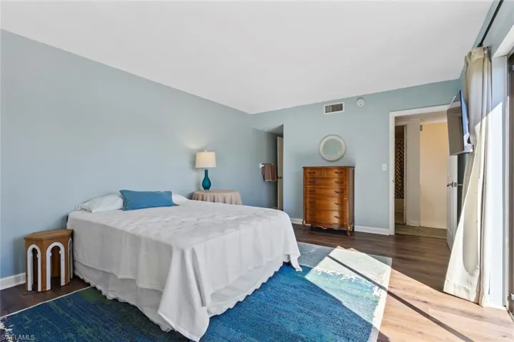 Primary Bedroom with dark wood-type flooring