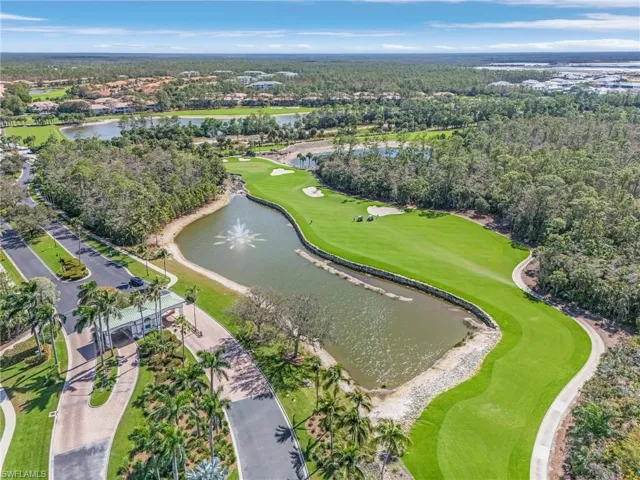 Aerial view of Forest Glen gated front entrance and the 13th fairway and pond.