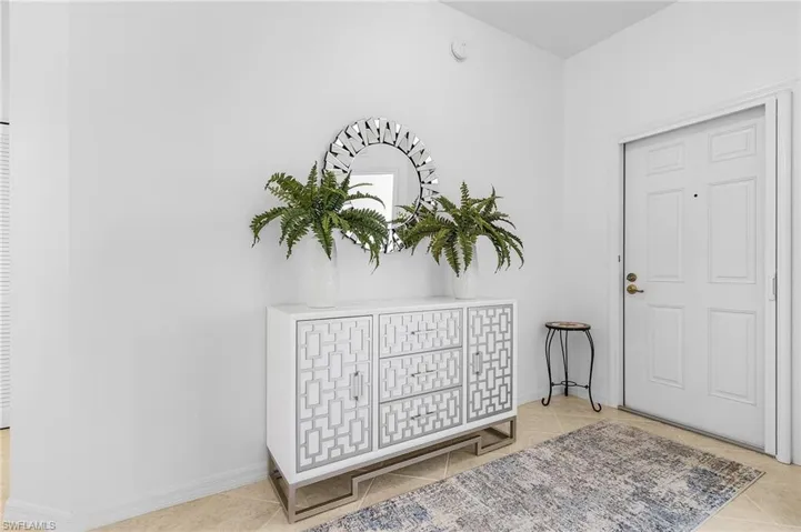 Foyer with light tile patterned floors.