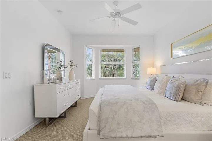 Primary bedroom faces South overlooking 4th fairway and pond with private bath and walk-in closets.