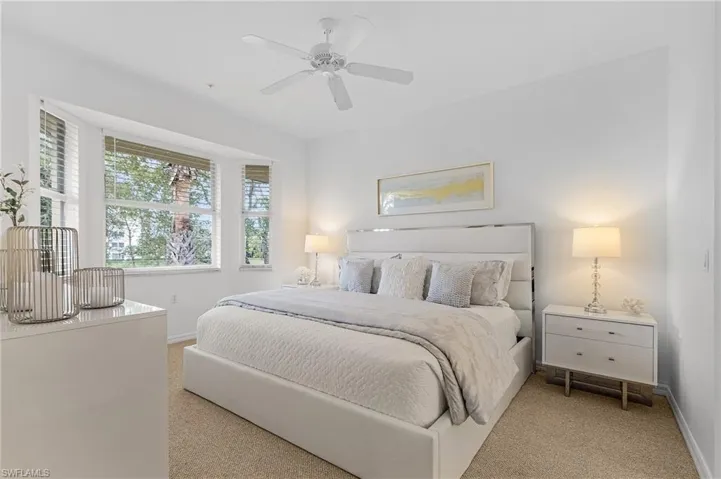 Primary bedroom faces South overlooking 4th fairway and pond with private bath and walk-in closets.