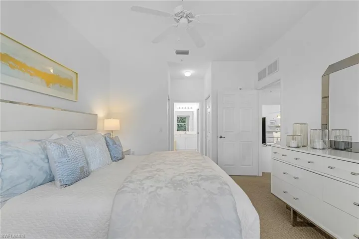 Primary bedroom faces South overlooking 4th fairway and pond with private bath and walk-in closets.