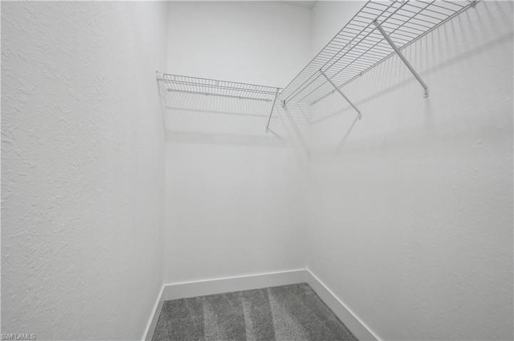 1 of 2 walk-in-closets in master bedroom