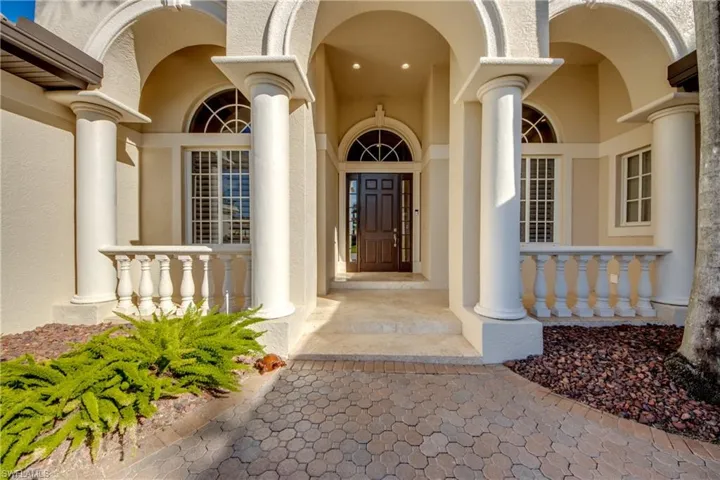 Front Loggia sitting area with Key West Travertine and elevated entrance into home
