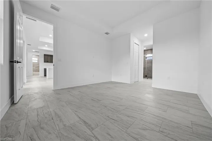 Unfurnished room with baseboards and recessed lighting