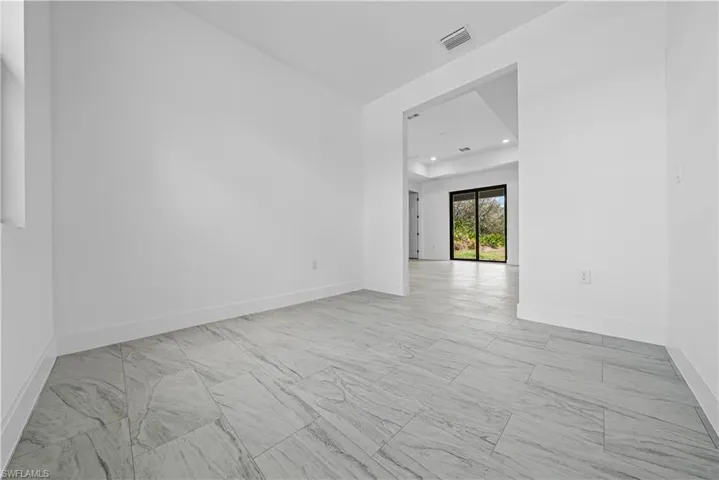 Unfurnished room featuring light marble finish flooring and recessed lighting