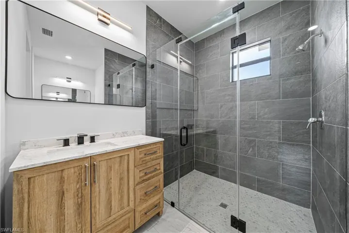 Bathroom with vanity and a shower stall
