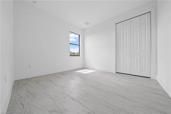 Unfurnished bedroom featuring baseboards and a closet
