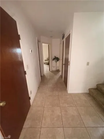 Hallway with light tile patterned floors