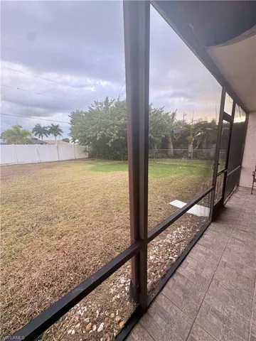 Fenced backyard with a sunroom