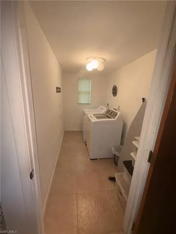 Laundry room featuring separate washer and dryer and baseboards