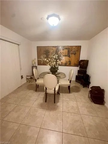 Dining space with light tile patterned floors