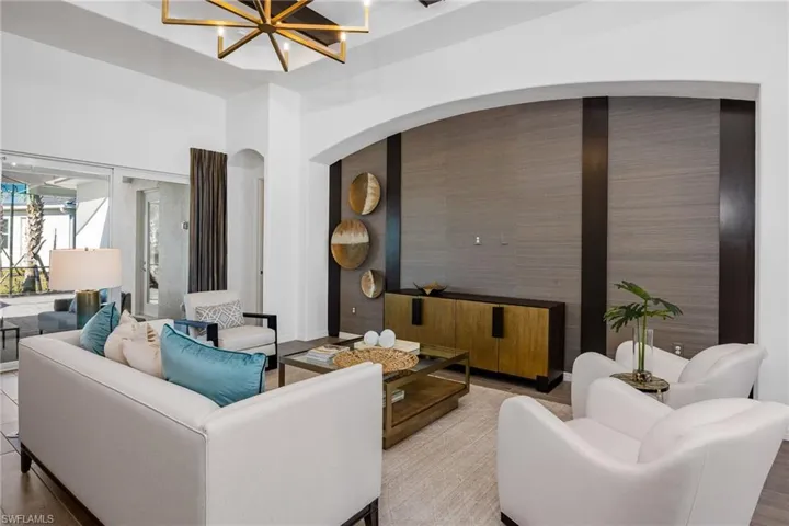 Living area with a chandelier and arched walkways