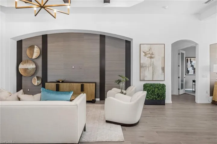 Living room with wood finished floors and a chandelier