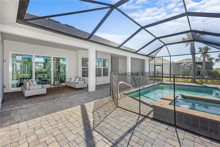 View of pool with a patio area, an outdoor living space, a pool with connected hot tub, and a lanai