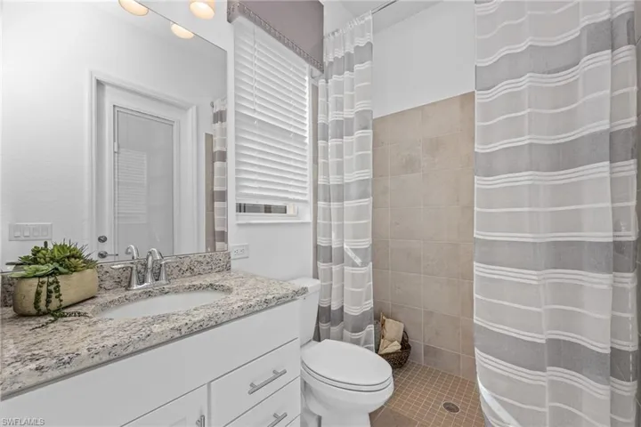 Full bathroom featuring vanity and a shower with shower curtain
