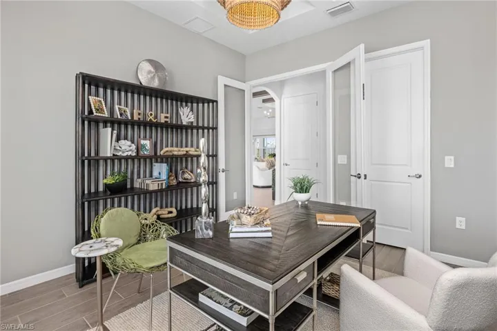 Home office featuring wood tiled floors and arched walkways