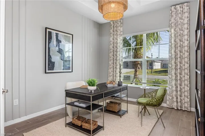 Office space with wood tiled floors and a chandelier