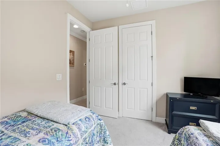 Bedroom featuring light carpet and recessed lighting