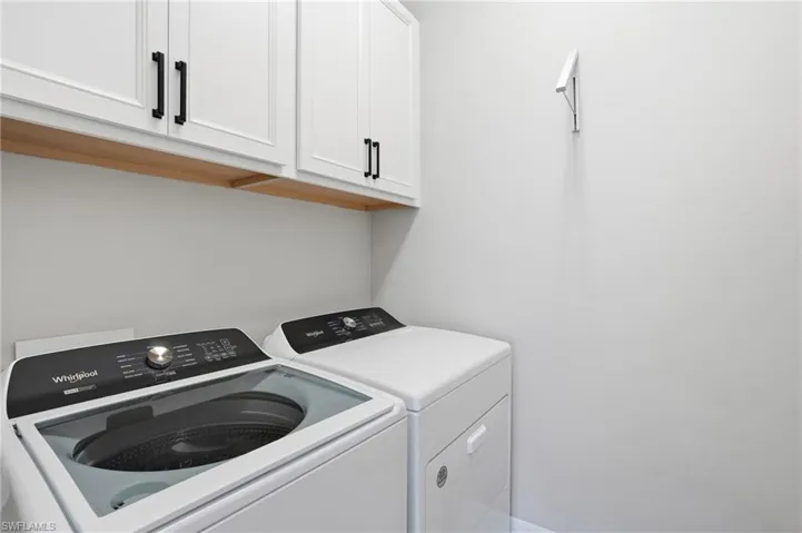 Laundry area with cabinet space and separate washer and dryer