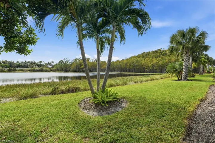 View of grassy yard with a water view