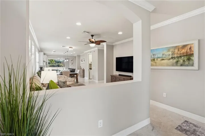 Unfurnished living room with crown molding, recessed lighting, light tile patterned flooring, and ceiling fan