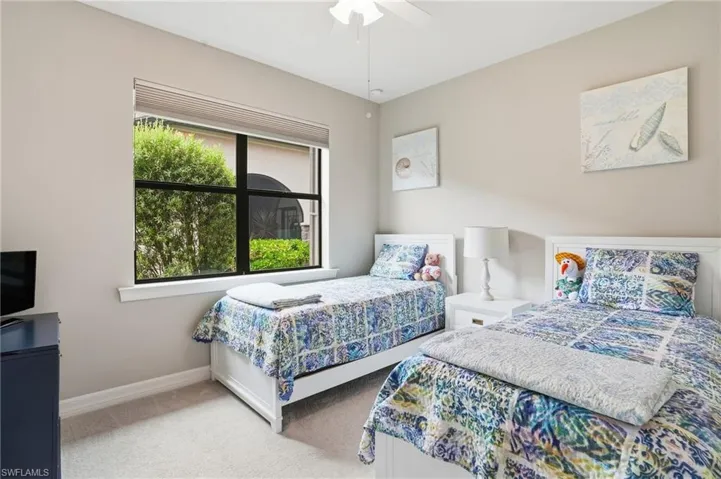 Bedroom with light colored carpet and ceiling fan