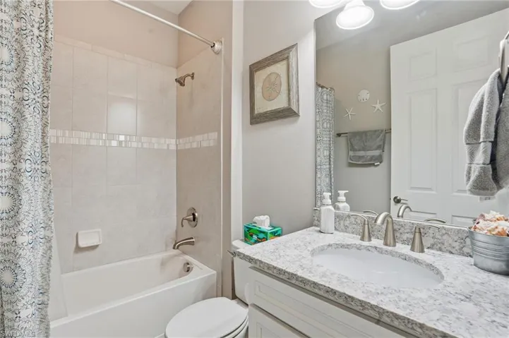 Full bathroom featuring shower / tub combo with curtain and vanity