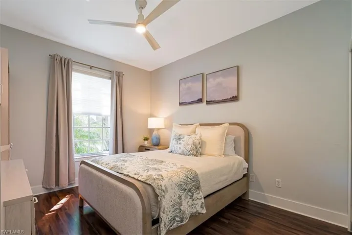 Bedroom featuring dark wood-style flooring and ceiling fan