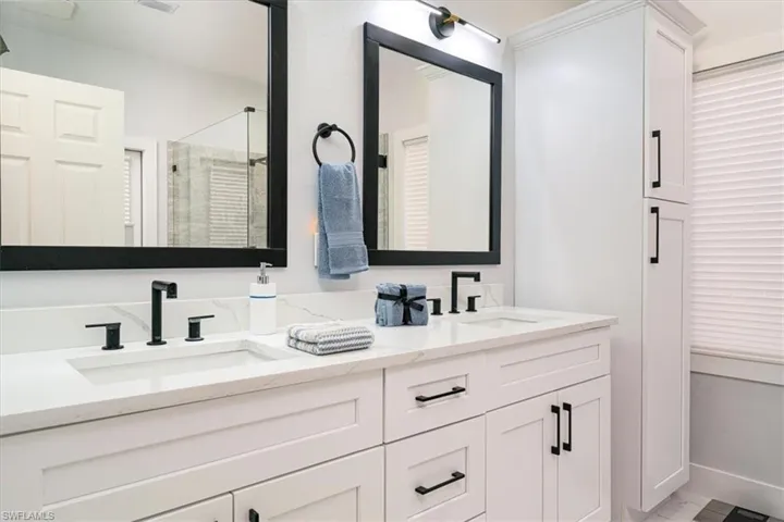 Bathroom with double vanity and a stall shower