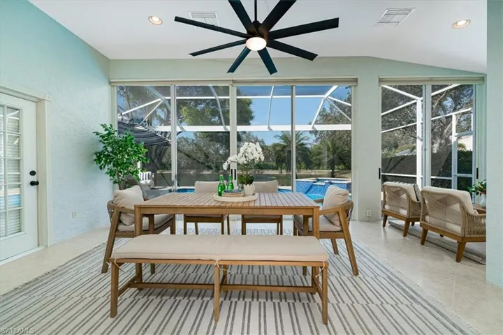 Sunroom / solarium featuring a patio, a jacuzzi, ceiling fan, and an outdoor living / dining area