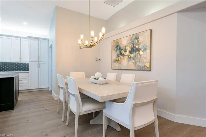 Dining space with light wood-type flooring and hanging lights